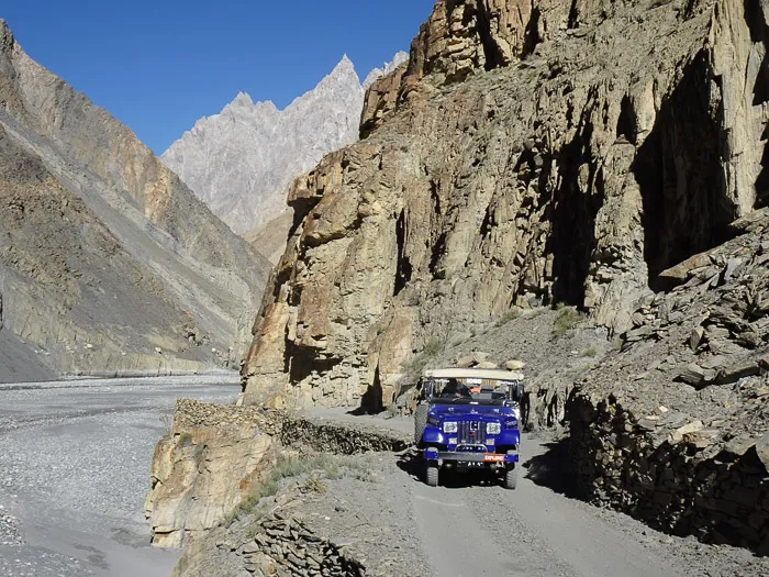 Yak herders drive their animals across the Shimshal river at the end of the winter kutch migration